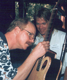 Jay Hargreaves  inspecting a Mark Wescott guitar with the builder